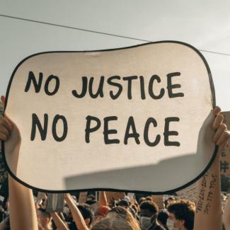 Bild zeigt Plakat mit Schrift - No Justice - no peace